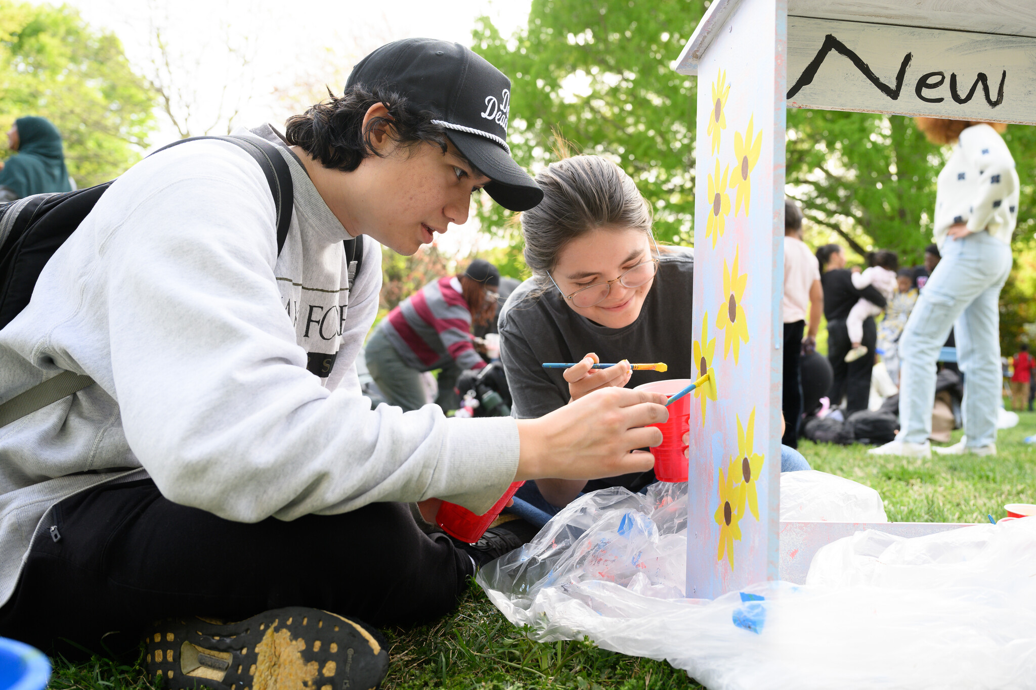Wake Forest University students paint desks alongside local school children at Davis Field on Wednesday, April 8, 2026 as part of Discovering Education through Student Knowledge (DESK). The event brings local elementary school children to campus each spring to create inspiring, colorful study spaces for students in their homes. A longstanding campus tradition, DESK was started in 2001 in partnership with Old Town Elementary after two WFU students identified a lack of workspace in the homes of the children they were tutoring.
