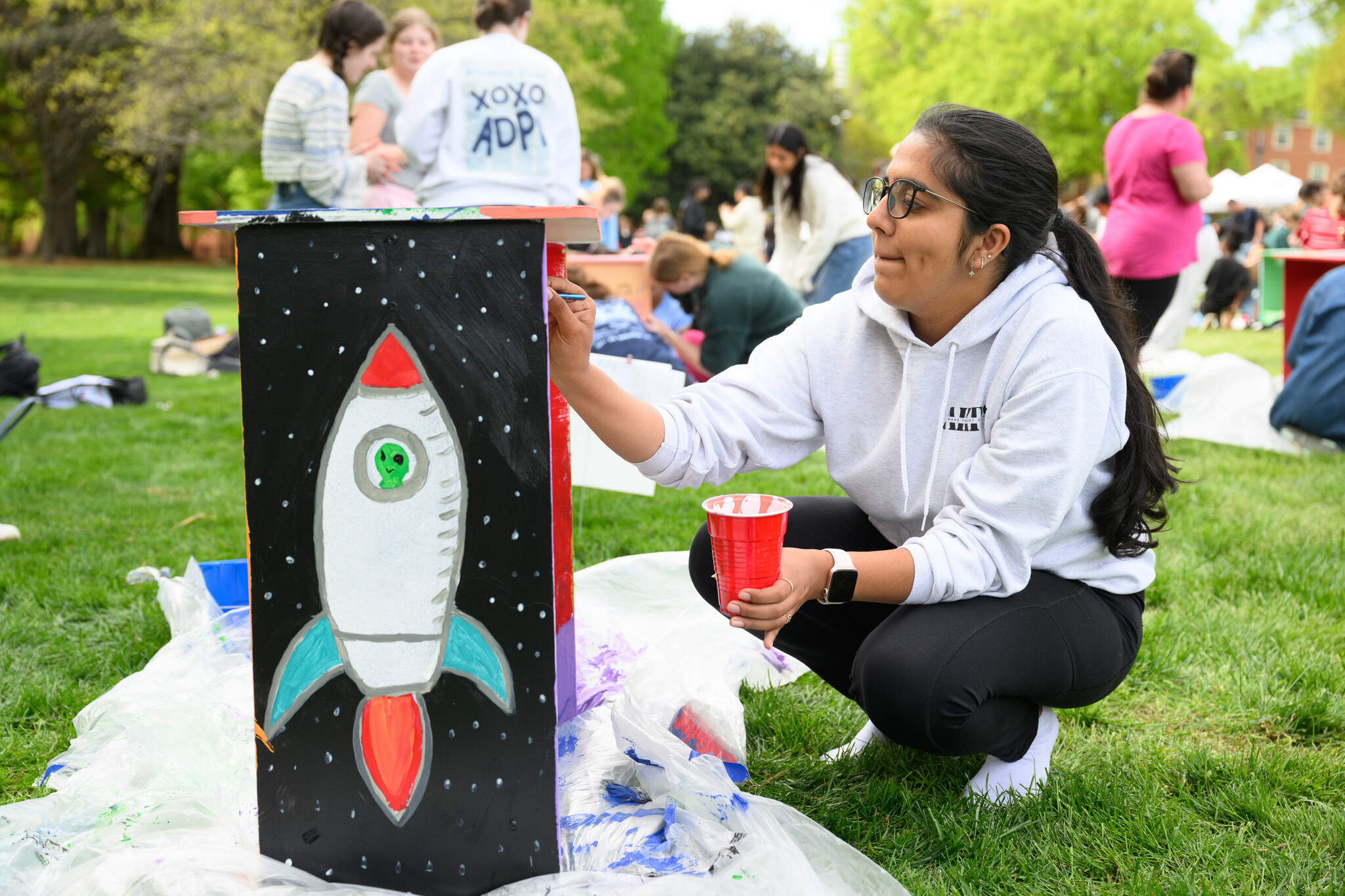 Wake Forest University students paint desks alongside local school children at Davis Field on Wednesday, April 8, 2026 as part of Discovering Education through Student Knowledge (DESK). The event brings local elementary school children to campus each spring to create inspiring, colorful study spaces for students in their homes. A longstanding campus tradition, DESK was started in 2001 in partnership with Old Town Elementary after two WFU students identified a lack of workspace in the homes of the children they were tutoring.