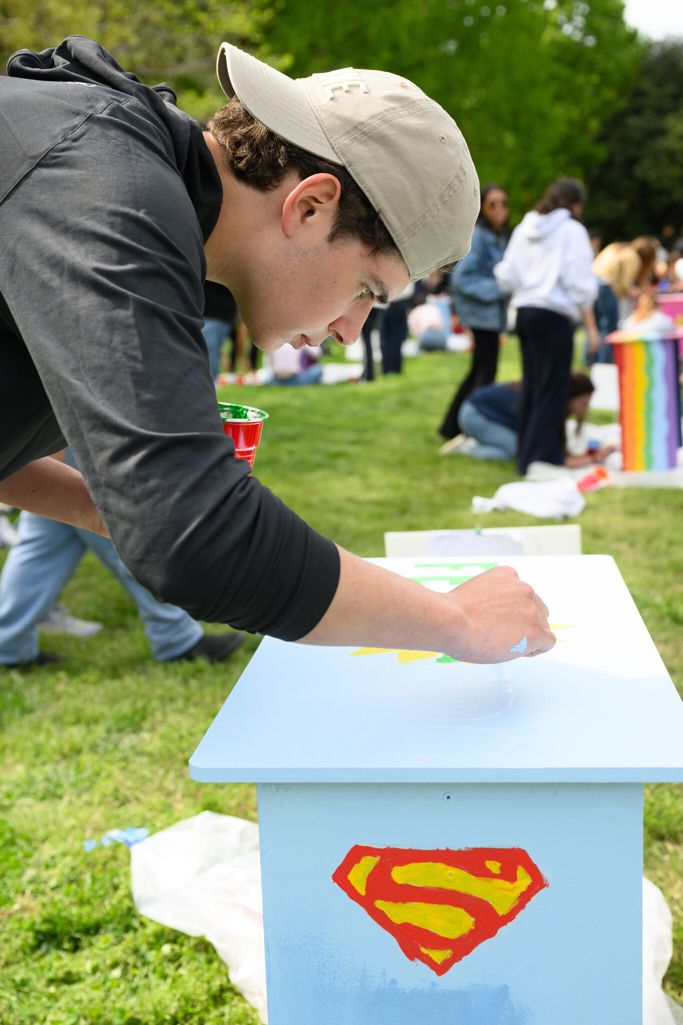 Wake Forest University students paint desks alongside local school children at Davis Field on Wednesday, April 8, 2026 as part of Discovering Education through Student Knowledge (DESK). The event brings local elementary school children to campus each spring to create inspiring, colorful study spaces for students in their homes. A longstanding campus tradition, DESK was started in 2001 in partnership with Old Town Elementary after two WFU students identified a lack of workspace in the homes of the children they were tutoring.