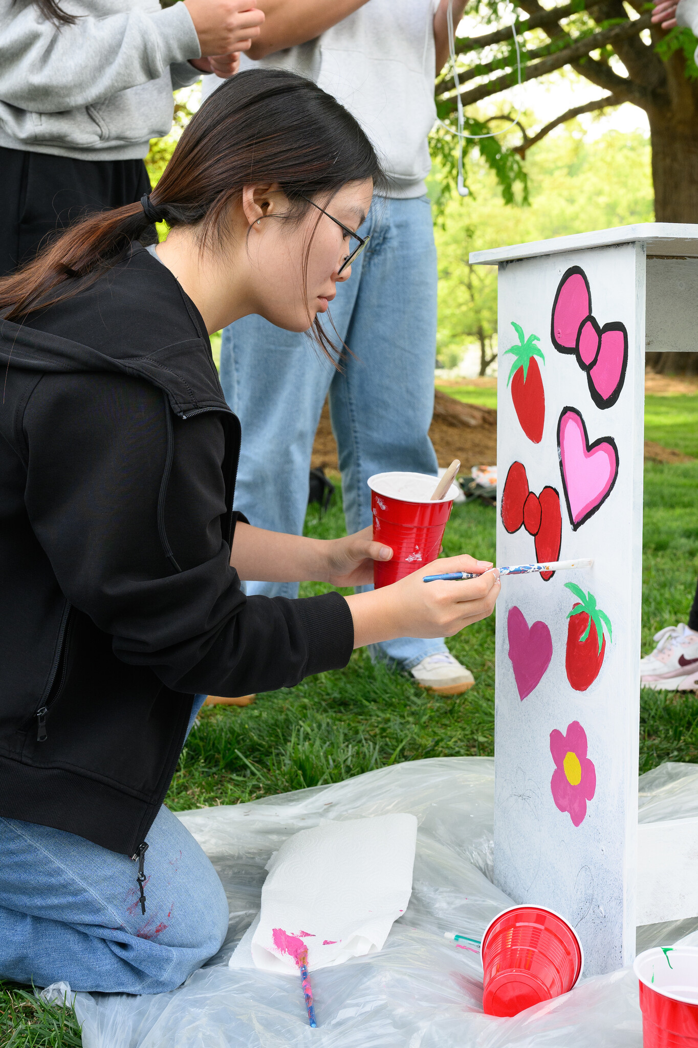 Wake Forest University students paint desks alongside local school children at Davis Field on Wednesday, April 8, 2026 as part of Discovering Education through Student Knowledge (DESK). The event brings local elementary school children to campus each spring to create inspiring, colorful study spaces for students in their homes. A longstanding campus tradition, DESK was started in 2001 in partnership with Old Town Elementary after two WFU students identified a lack of workspace in the homes of the children they were tutoring.