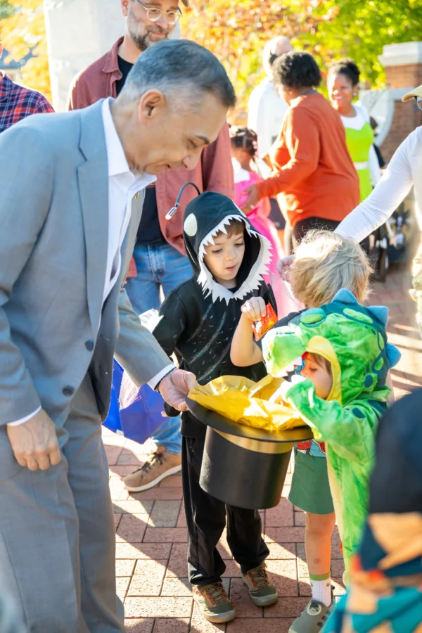 President Rodriguez offers candy to trick or treaters at Project Pumpkin
