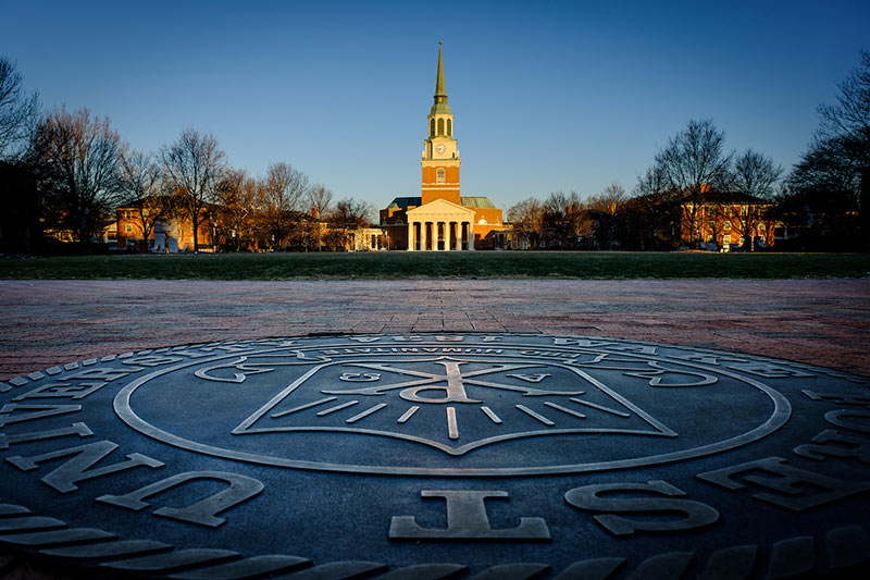 Student Financial Aid: The Wake Forest campus is lit by the rising sun.