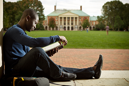 Student studying on the Quad