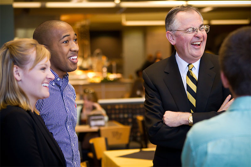 Wake Forest President Nathan O. Hatch talks with several Presidents Aides in the Reynolda Fresh Food company.