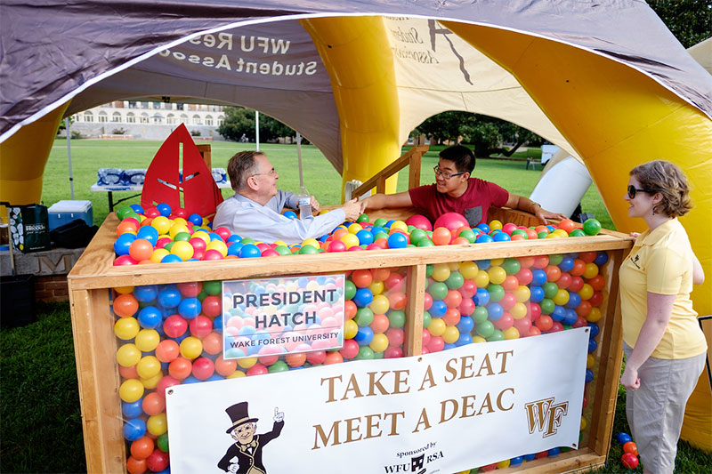 Wake Forest hosts move-in day for first year students at the south campus residence halls on Friday, August 21, 2015. President Nathan O. Hatch talks with a student in the ball pit on the lower quad.