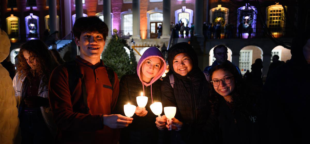 Students share candle light at the Lighting of the Quad