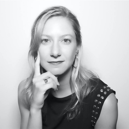 Headshot of Kelly Laffey, she looks pensive with her hand resting under her chin