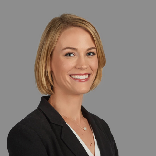 Headshot of Liz Shumate, she is wearing suit jacket and a smile