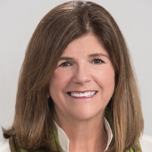 Headshot of Vicky Mitchener, she has brown hair and a smile