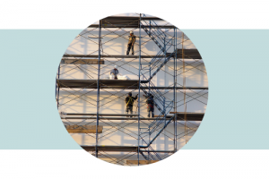 Scaffolds on a building with workers climbing on it