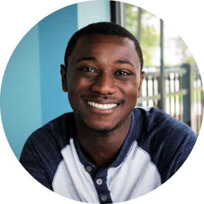 Man in blue and white shirt smiling at the camera