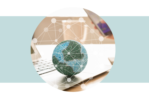 Globe sitting on a laptop computer with white connection lines overlaid on top of the photo