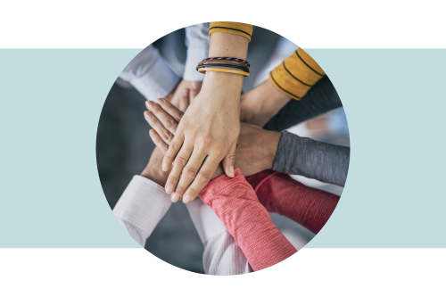Multiple people's arms and hands in a huddle