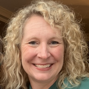 Woman with blonde hair smiling at the camera