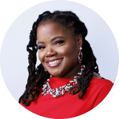 Photo of a woman wearing a red top smiling at the camera