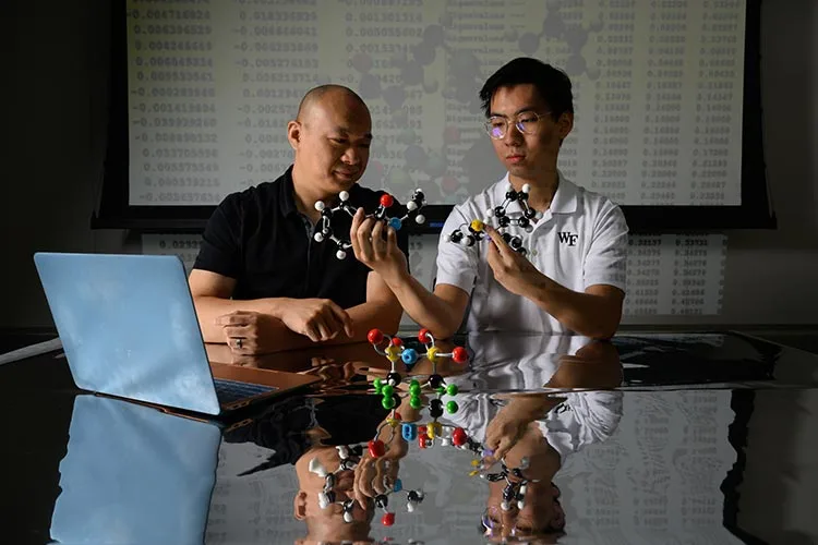 Chemistry Prof. Wendu Ding and URECA Scholar Leo Liu, ’26, pose for portrait in Salem Hall for a story about their research.