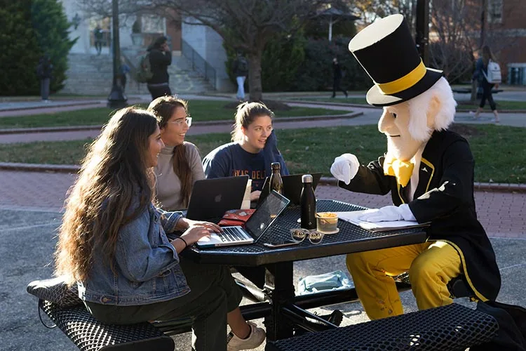 The Demon Deacon joins students who are studying on campus.