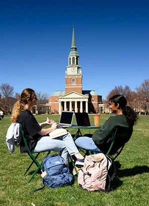 Students talking on Hearn Plaza with Wait Chapel in the background.
