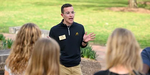 Admissions student tour guide giving families a campus tour