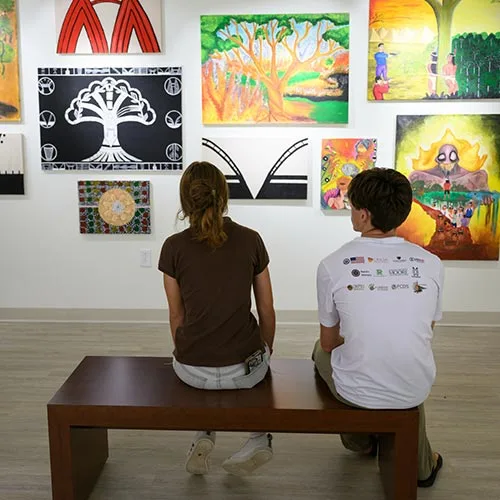 Wake Forest University students attend the exhibit opening reception for MINE: What is Ours in the Wake of Extraction? at the LAM Museum of Anthropology.