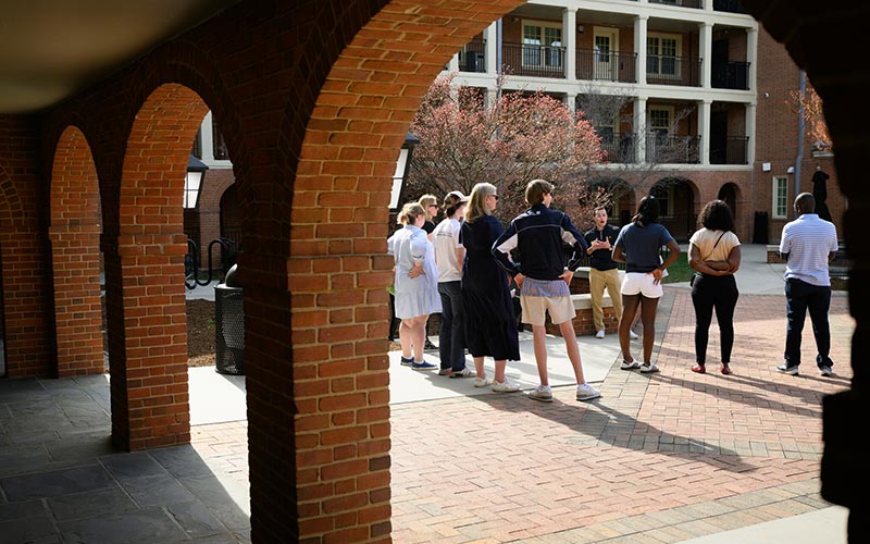 An admissions tour guide gives visiting families a tour of the Wake Forest campus