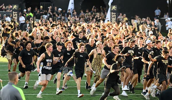First-year students rush the football field during Wake Forest's season opener.