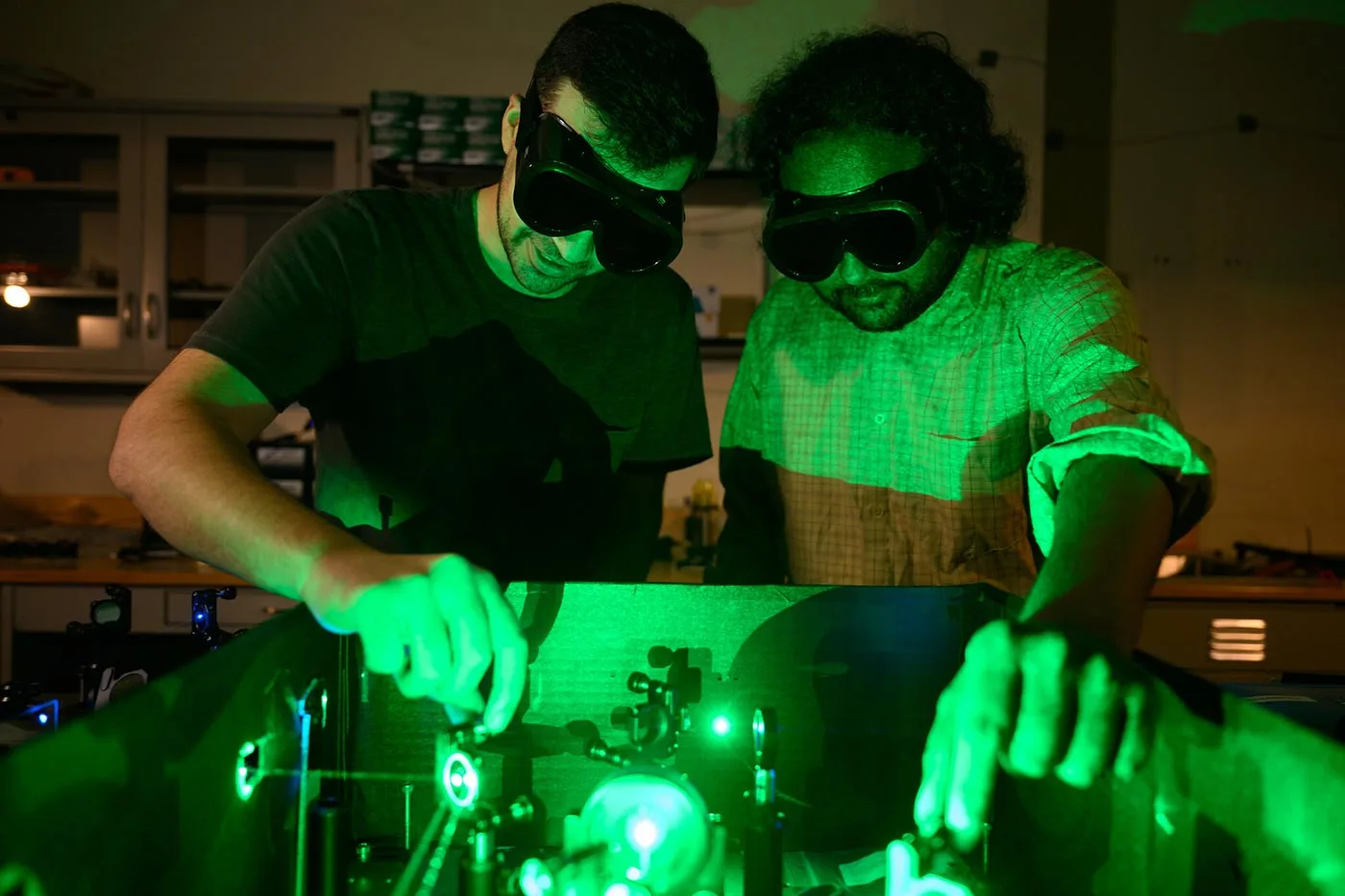 Physics students and Professor Ajay Ram Srimath Kandada work on research together in the laser lab in the Olin Physics Laboratory.
