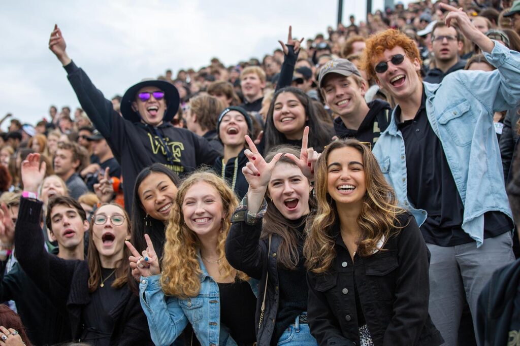 Wake Forest students cheer on their Demon Deacons during a football game.