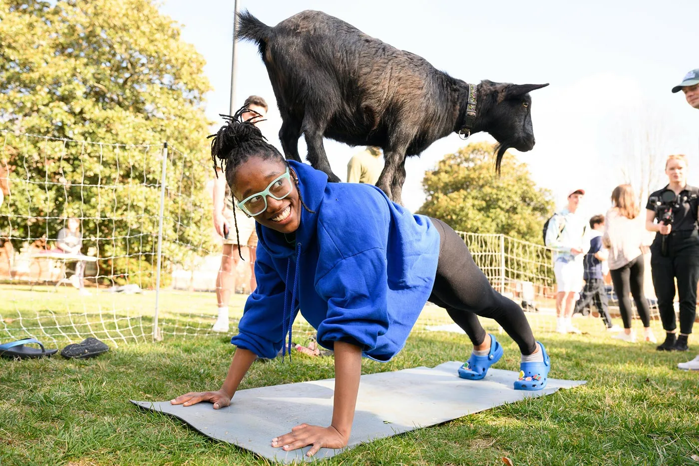 Students participate in yoga with goats as part of a wellbeing initiative sponsored by Campus Life.