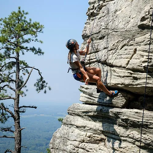 First-year students in the Wilderness to Wake pre-orientation program climb at Pilot Mountain State Park.
