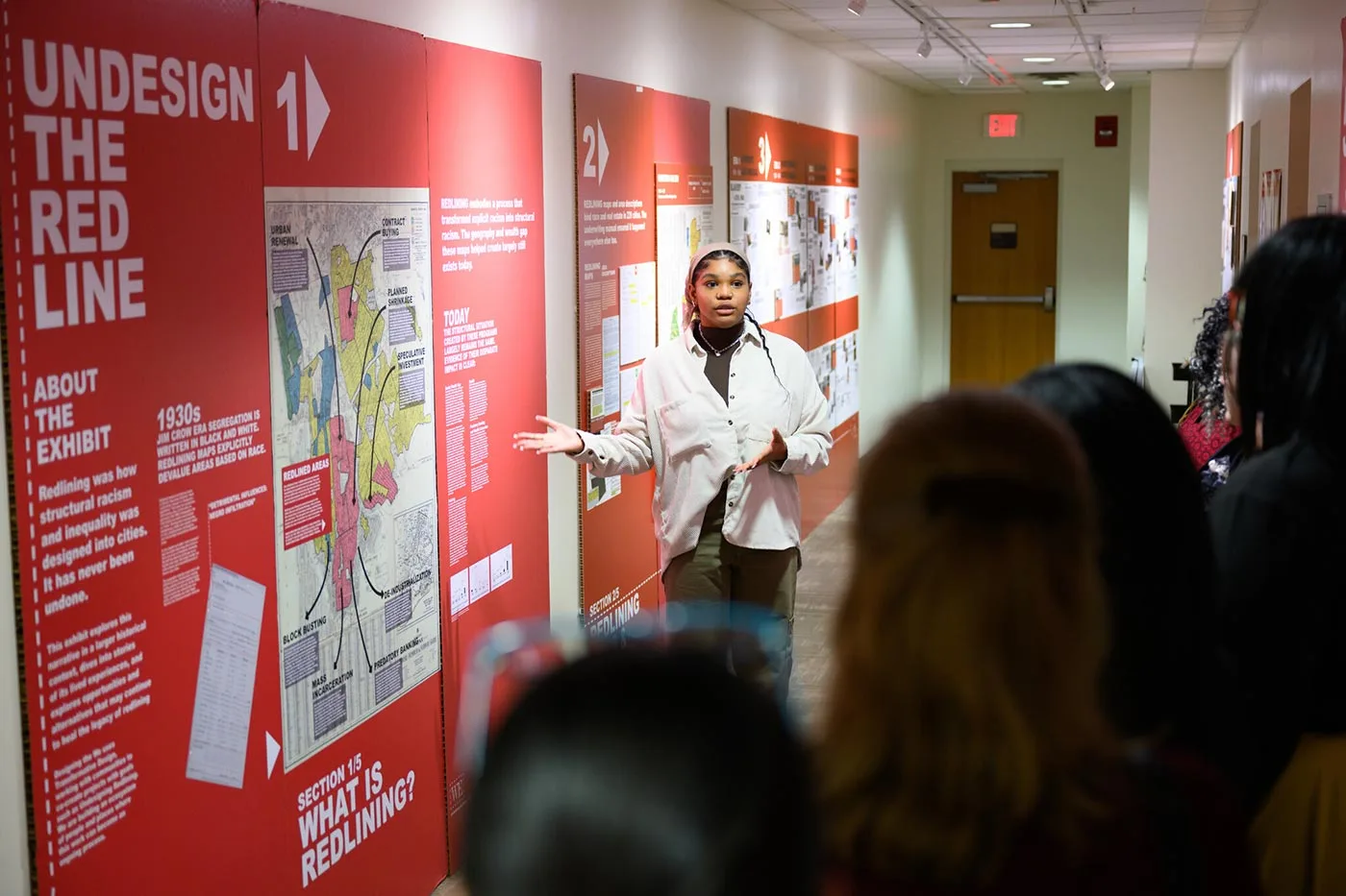 Students attend the Undesign the Redline Exhibit, a traveling exhibition that examines the history and consequences of redlining, a discriminatory practice that denied access to home loans and insurance to people of color and immigrants in the 20th century.