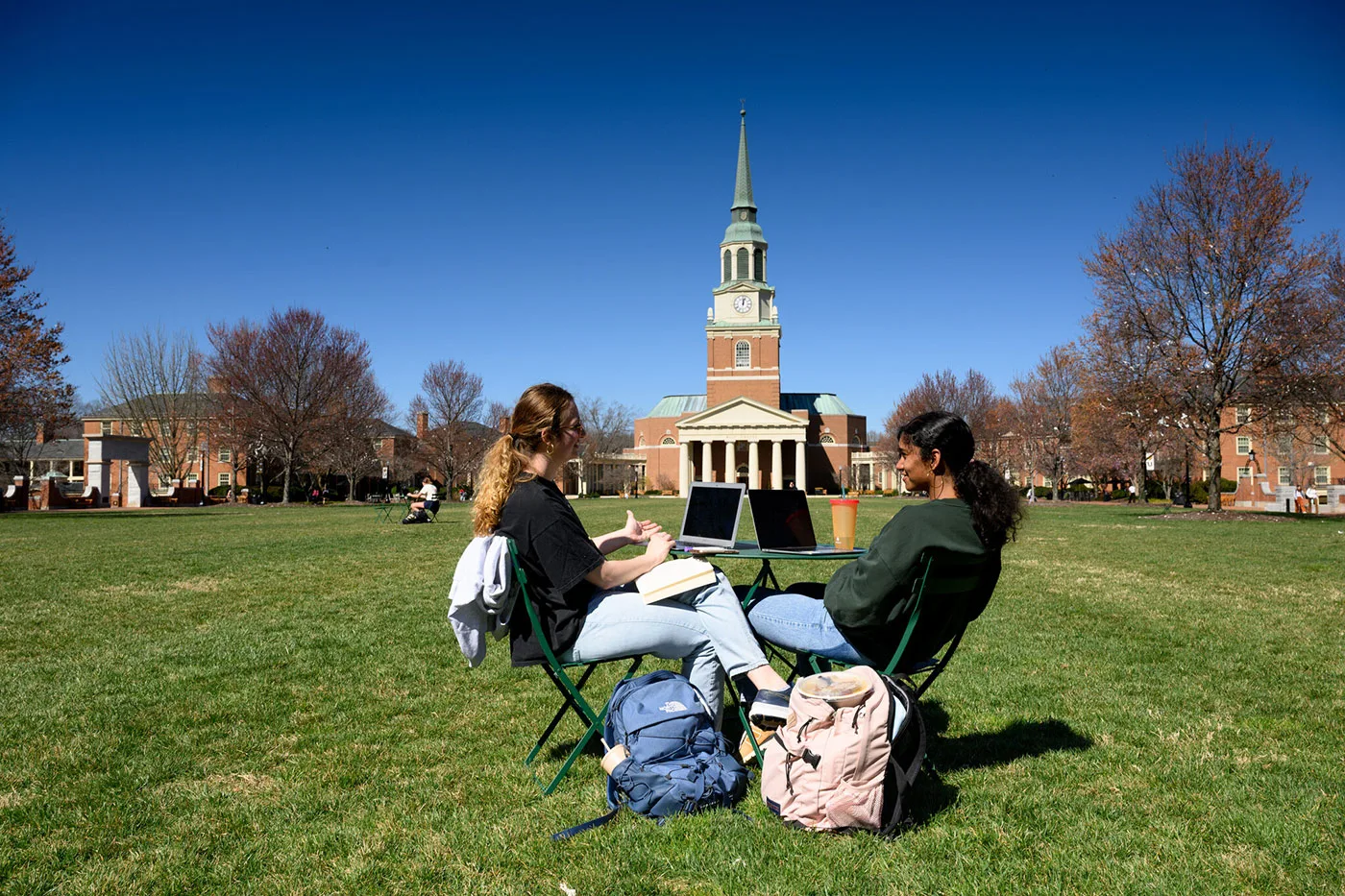 Students have a conversation with one another on Hearn Plaza