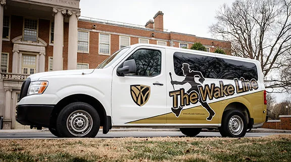 A Wake Line shuttle van sports new Demon Deacon graphics outside the library on Wednesday, January 10, 2018.