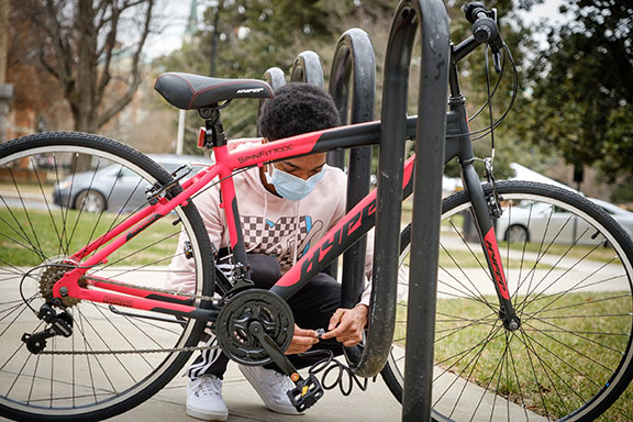 Wake Forest student locks up his bike outside Johnson Residence as he returns for the beginning of the Spring 2021 semester on Sunday, January 24, 2021.