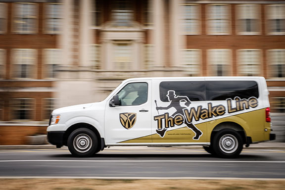 A Wake Line shuttle van sports new Demon Deacon graphics outside the library