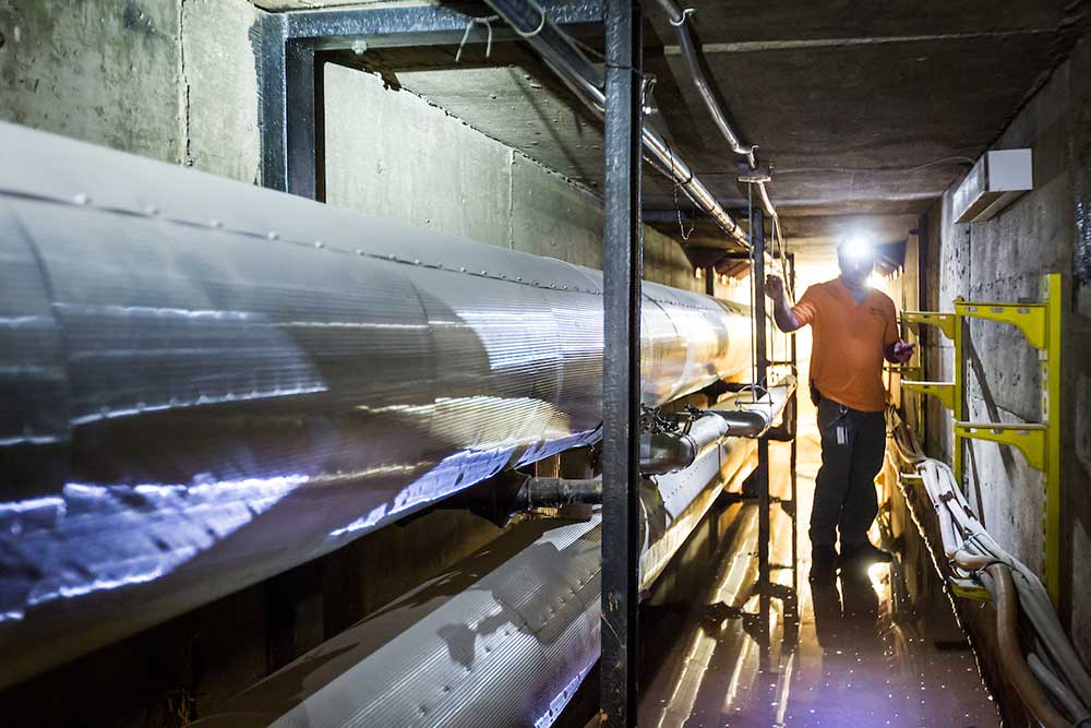 Wake Forest Environmental Health and Safety employee Justin Sizemore checks air quality in the steam tunnel