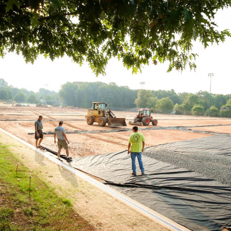 contractors work on drainage of field