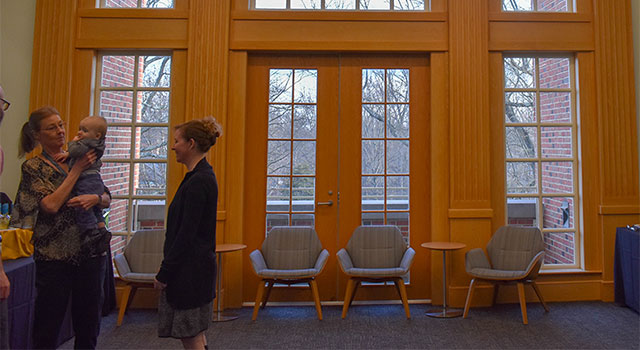 Faculty & Staff socializing in Wilson Wing of Library