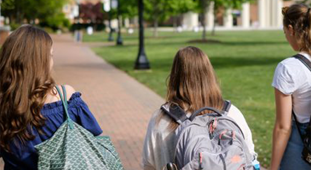 students walk along sidewalk