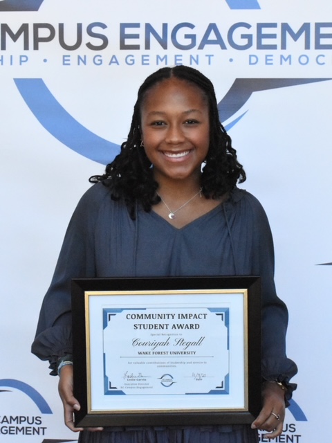 Wake Forest University Student Couriyah Stegall is presented with the Community Impact Student Award by NC Campus Engagement for her commitment and contribution to civic and community engagement. 