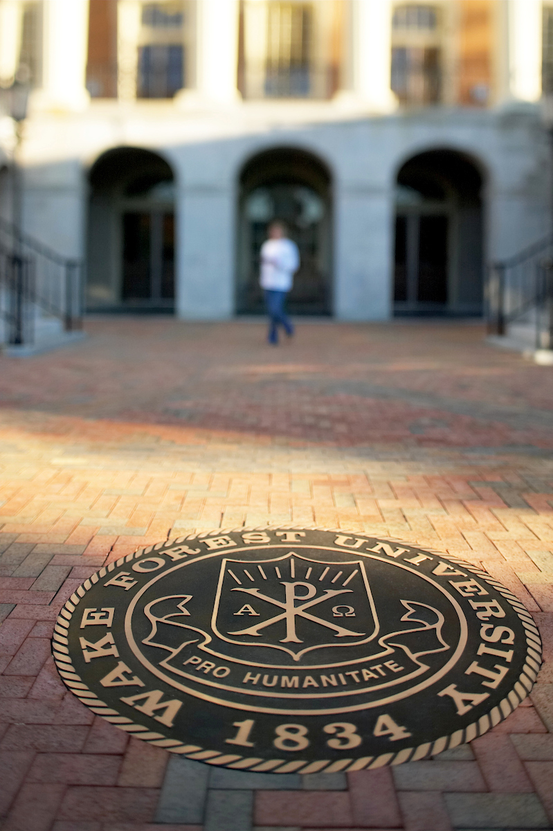 The Seal of Wake Forest University inset in the new brick walkway in front of Reynolda Hall on the Quad.