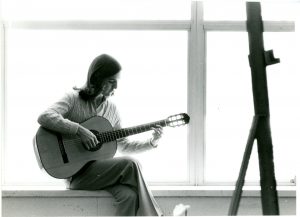 Patricia Dixon with a guitar.