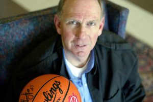 Richard Carmichael posing with a signed basketball.