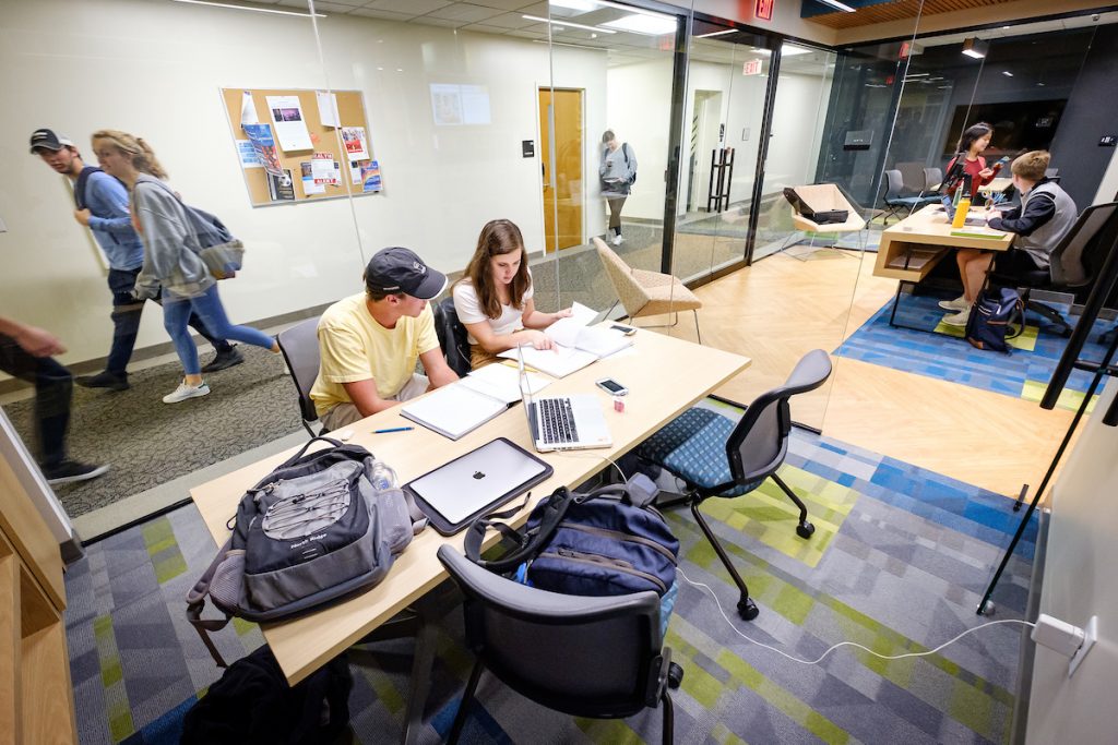 Students sit at a desk to work during a tutoring session at the new Math & Stats Center.