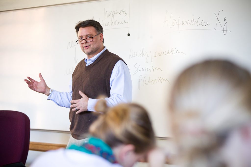 Wake Forest religion professor Stephen Boyd stands at the white board for his introduction to Christianity class