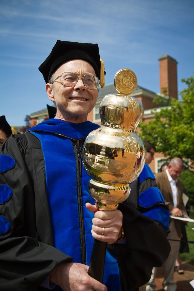 History professor Michael Hughes in his regalia leads the procession with the university mace.