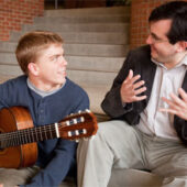 Presidential Scholar John Kossler receives some instruction from Chilean classical guitar virtuoso Carlos Perez.