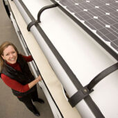 Sustainability director Dedee DeLongpré Johnston, with the newest-model solar-electric hybrid shuttle, now operating on the Reynolda Campus: "Sustainability is a competitive advantage in the marketplace."