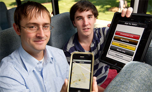 Seniors Michael Crouse, left, and Tom Loughran ride the Wake Line shuttle bus as they display their new iPhone and iPad application that tracks the shuttle in real time using GPS technology.