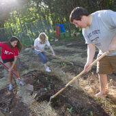 As part of their spring biology class, Emily Earle, Kris Frantz and Nick Conte work in the campus garden to learn about plant physiology, sustainability and community service.